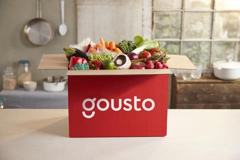 Open Gousto box filled with vegetables on a kitchen counter