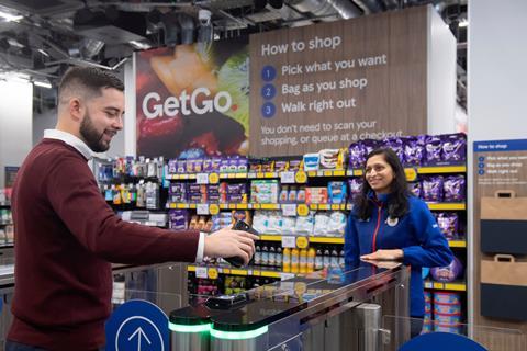 Tesco GetGo counter with customer and staff member helping