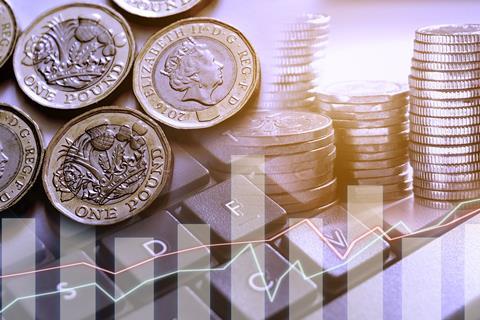 Pound coins on top of a graphic showing stocks and shares