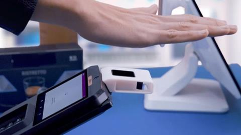 Hand making payment via Ingenico palm payment technology