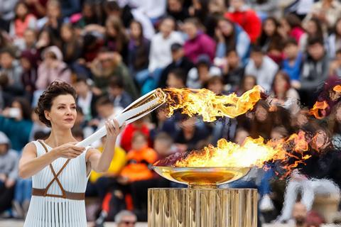 Woman lighting the Olympics torch