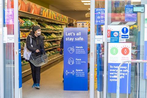 Customer observing social distancing in Tesco store