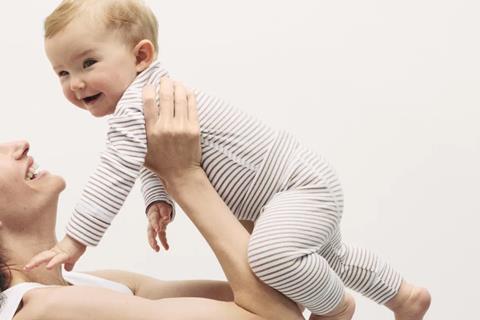 Mother holding happy baby