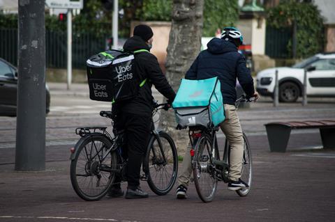 Deliveroo and Uber Eats riders in the street