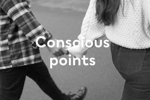 Black and white image of two people holding hands from the back with text saying 'Conscious points'