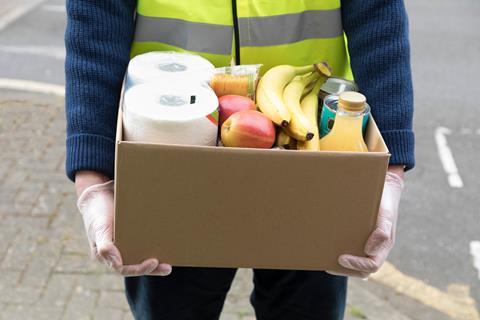 Courier delivering box of groceries from supermarket