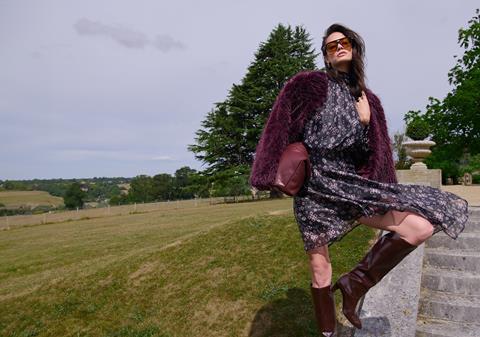 Woman wearing patterned dress and faux fur coat from The Very Collection
