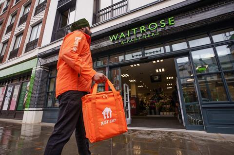 Just Eat delivery person outside a Waitrose store