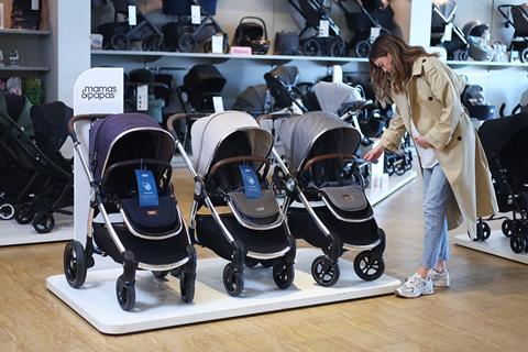 Woman looking at pushchairs at Mamas & Papas store