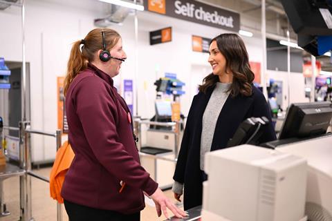 Sainsbury-employee-with-headset-talking-to-customer-in-store