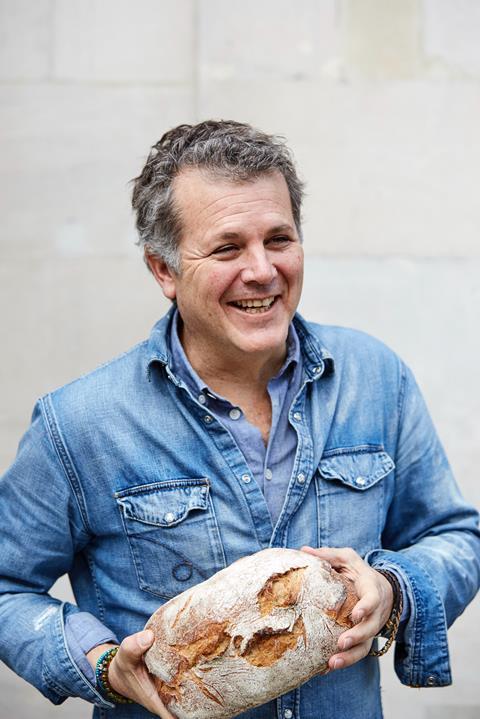 Gail’s boss Tom Molnar holding loaf of break