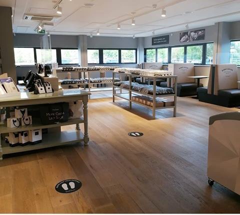 The cafe area inside Hotel Chocolat's new 'drive-to' outlet store features socially distant seating.