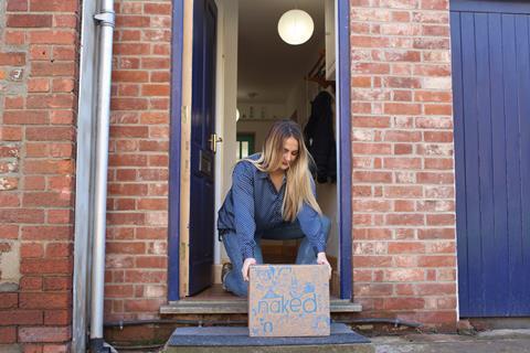 A woman taking delivery of a Naked Wines box from her doorstep
