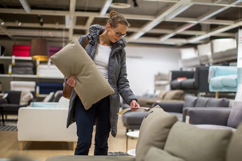 Woman buying a sofa in a furniture store