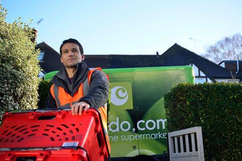 Ocado delivery driver next to his van