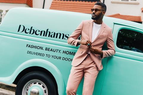 Model in suit next to Debenhams delivery van