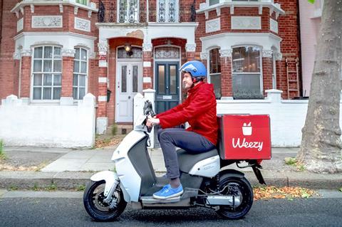 Weezy delivery rider outside a row of houses