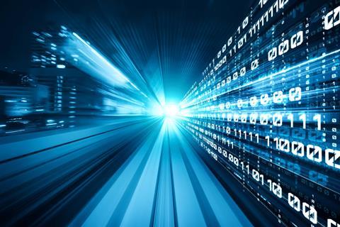 Binary code, skyscrapers and bright light to illustrate digital transformation