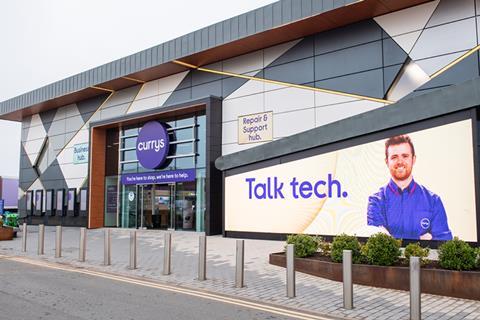 Exterior of Currys store. Sign shows an employee and reads: 'Talk tech.'