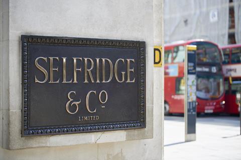 Brass Selfridges sign on London store wall