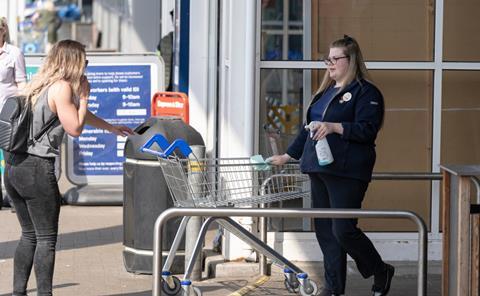 Tesco staff interacting with a customer
