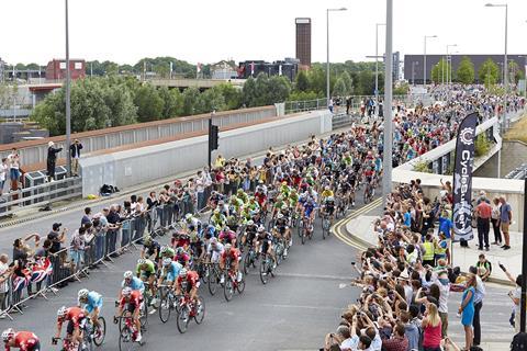 Cyclists ride past Westfield Stratford City.