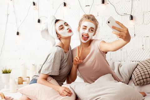 two girls with selfie beauty masks_shutterstock_1130833667