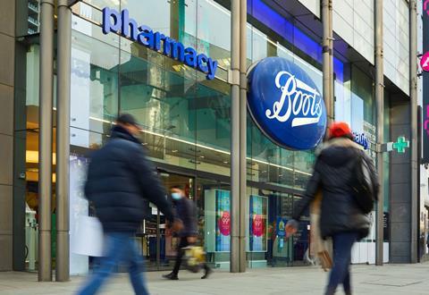 Exterior of Boots store with people walking past